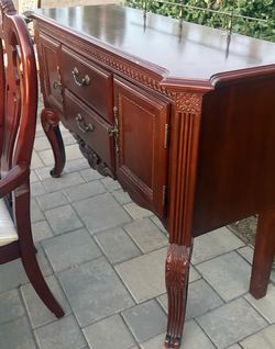 Table two chairs and curio cabinet