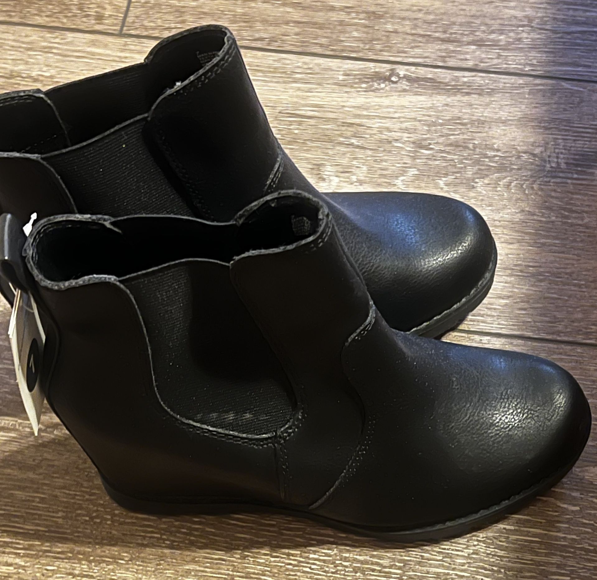 This is a pair of Maurices Chelsea wedge ankle booties in black faux leather