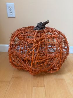 Wooden and grape vine wrapped pumpkin