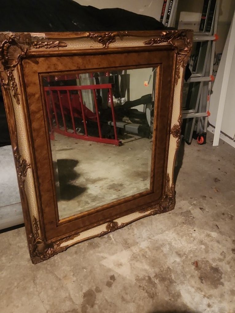 Vintage French-style ornate gold and cream mirror.