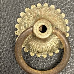 Royal St. John sewing machine drawer pull, brass & steel. Approximately 1 3/8” in diameter.