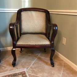 Chair covered in beige fabric w/nail trim