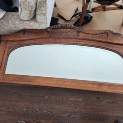 ANTIQUE CARVED OAK AND BEVELED MIRROR