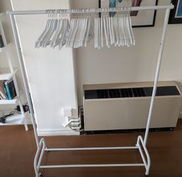 metal clothes rack with wooden hangers