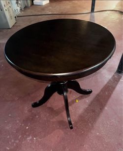 round dinner table with 2 floral chairs