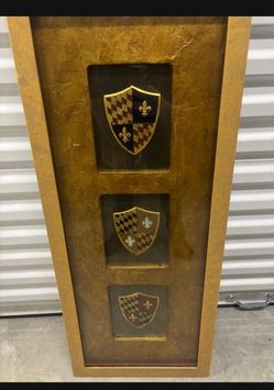 Framed medieval shields.. ready to hang by John Richard. 16” x 39” $50
