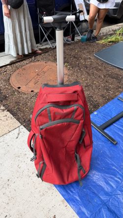 Red orange rolling duffle bag plus back pack