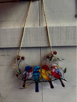 Cute birds as a hanging suncatcher made of plastic