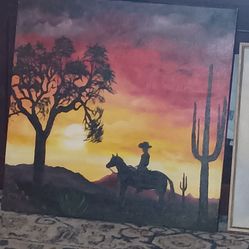 Canvas painting cowboy riding into the sunset