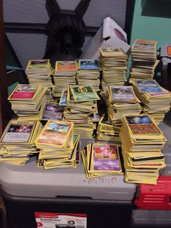 Thousand of pokemon playing cards in stacks and binders