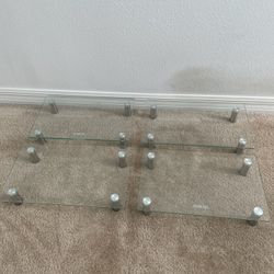 4 x Glass Monitor Stands with height adjustable ~ 15”L x 10”W X 3”H per stand   Price listed includes for all four stands 