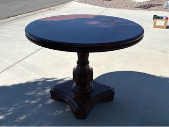 HEAVY SOLID WOOD ROUND TABLE 4 FT ACROSS BY 3 FT TALL ASKING  $50 for IT