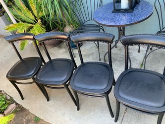Set of four black leather and wood bistro dining chairs maybe by Pottery Barn.