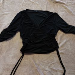 Chic black wrap blouse with ruched detailing. Perfect for versatile styling. 
