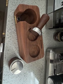 This is an espresso tamper station, used for making espresso coffee.  From the photo:  * The top round holder is used to hold the portafilter while ta