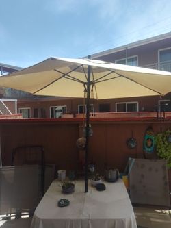 Patio set in good condition four chairs umbrella and table