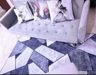 Gray sleeper sofa with three throw pillows barely used