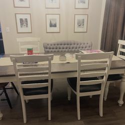 Table With Four White Chairs