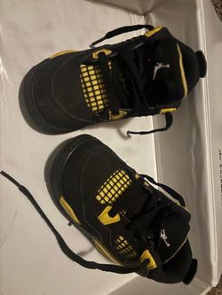 black and yellow child size 7 jordan 4’s