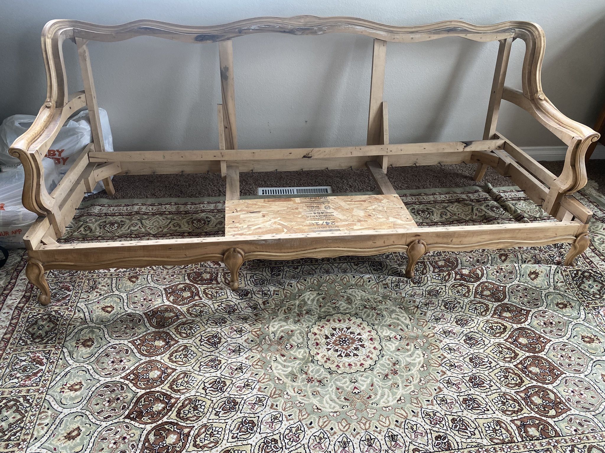 Antique stripped couch frame with materials
