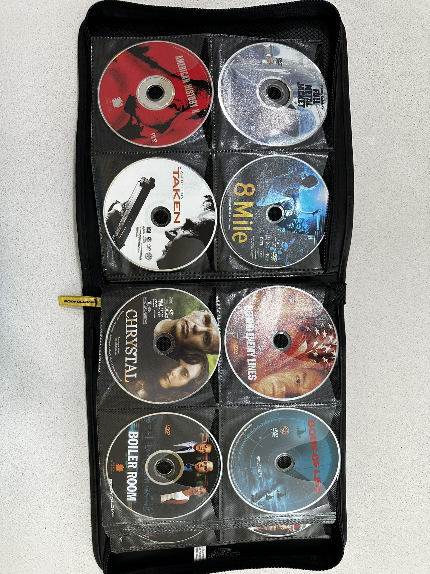 DVD Bundle Qty: 93 Assorted Title And Genres Including Storage Pouch.