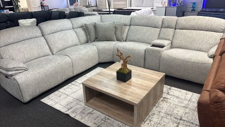 Power reclining sectional completely modular with hidden cup holder and  wireless charger.  Brand new in a box!