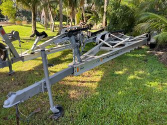 Aluminum triple Axel trailer up to 32’ boat or 18,000lb. Registration. New Axel, new lights, new carpet, new wires. Good 15’ tires on 6 lug rims. No w