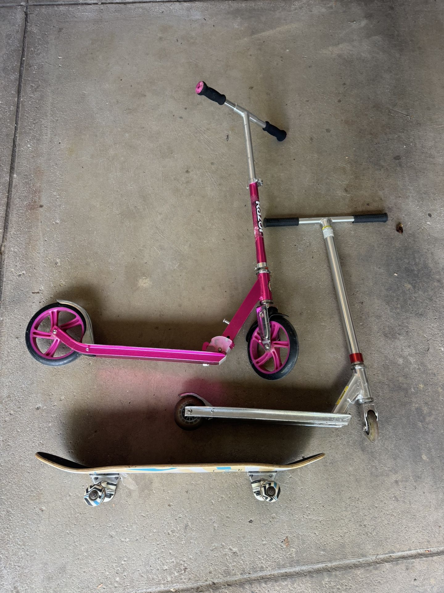 2 Razor Scooters And Skateboard