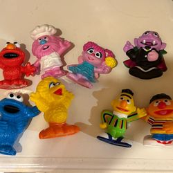 Sesame Street figures and Cocomelon Musical Bus And Figurine