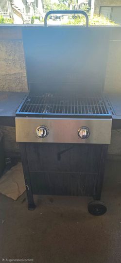Gas propane grill and gas tank with gas.