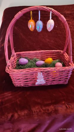 Colorful Easter eggs and basket with bunnies on it.