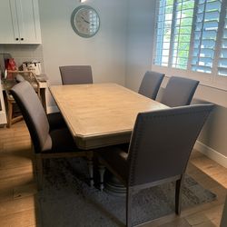 Wood Dining Table with 6 Gray Upholstered Chaors and Leaf