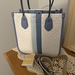 Michael Kors purse with strap. Approximately 11hx 11wx 5d. Comes from a smoke free home. Only carried a short while.