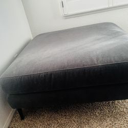 blue square ottoman with black legs 
