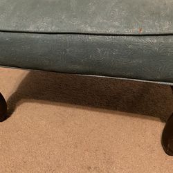 Turquoise or light blue stool or ottoman with brown wooden legs!