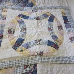 handmade quilt or quilted pillow shams featuring a traditional Double Wedding Ring pattern. 
