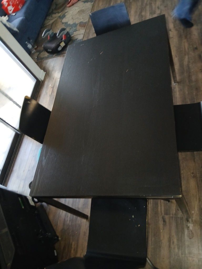 Wooden table with four chairs included