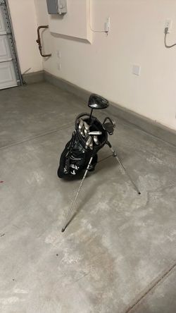 Calloway golf bag with irons, Cleveland black square putter, and Cleveland Black driver