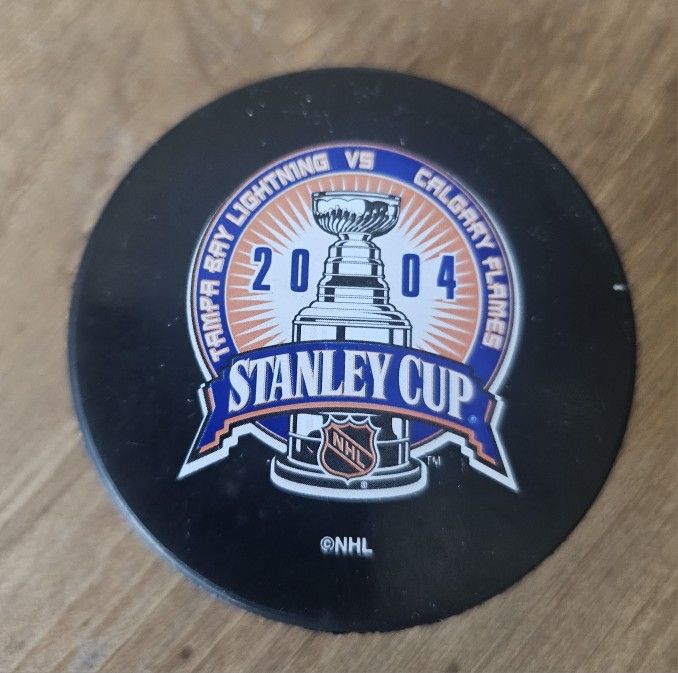 2004 Stanley Cup Finals Puck - Tampa Bay Lightning vs Calgary Flames - NHL Collectible commemorative hockey puck from the 2004 Stanley Cup Finals