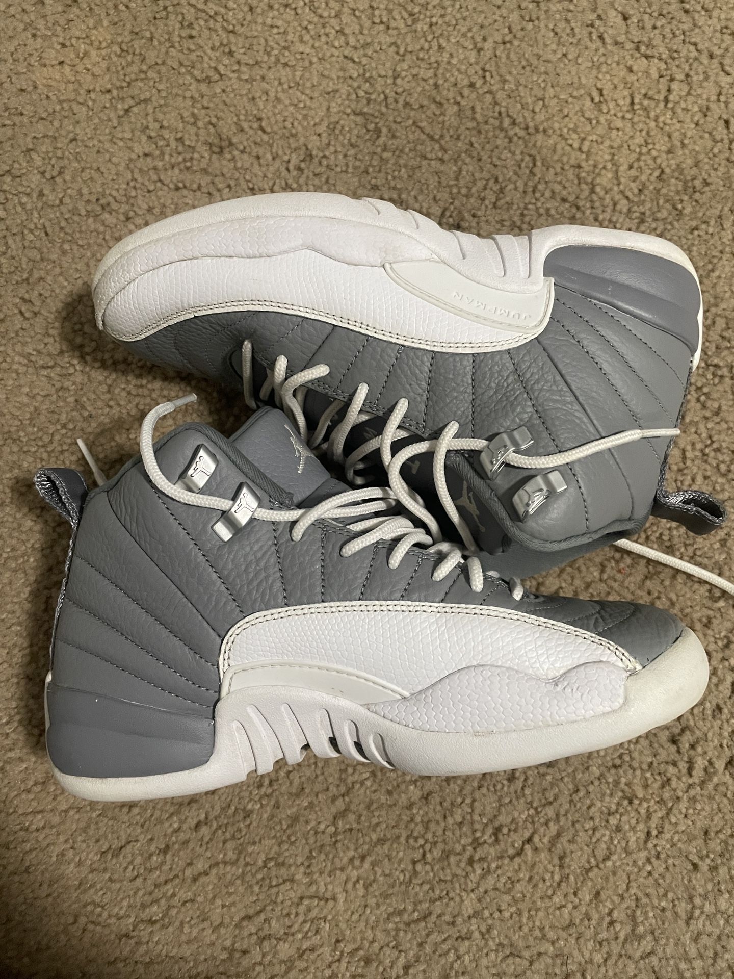 Youth Nike Air Jordan 12 Retro "Stealth" sneaker in the grey and white colorway
