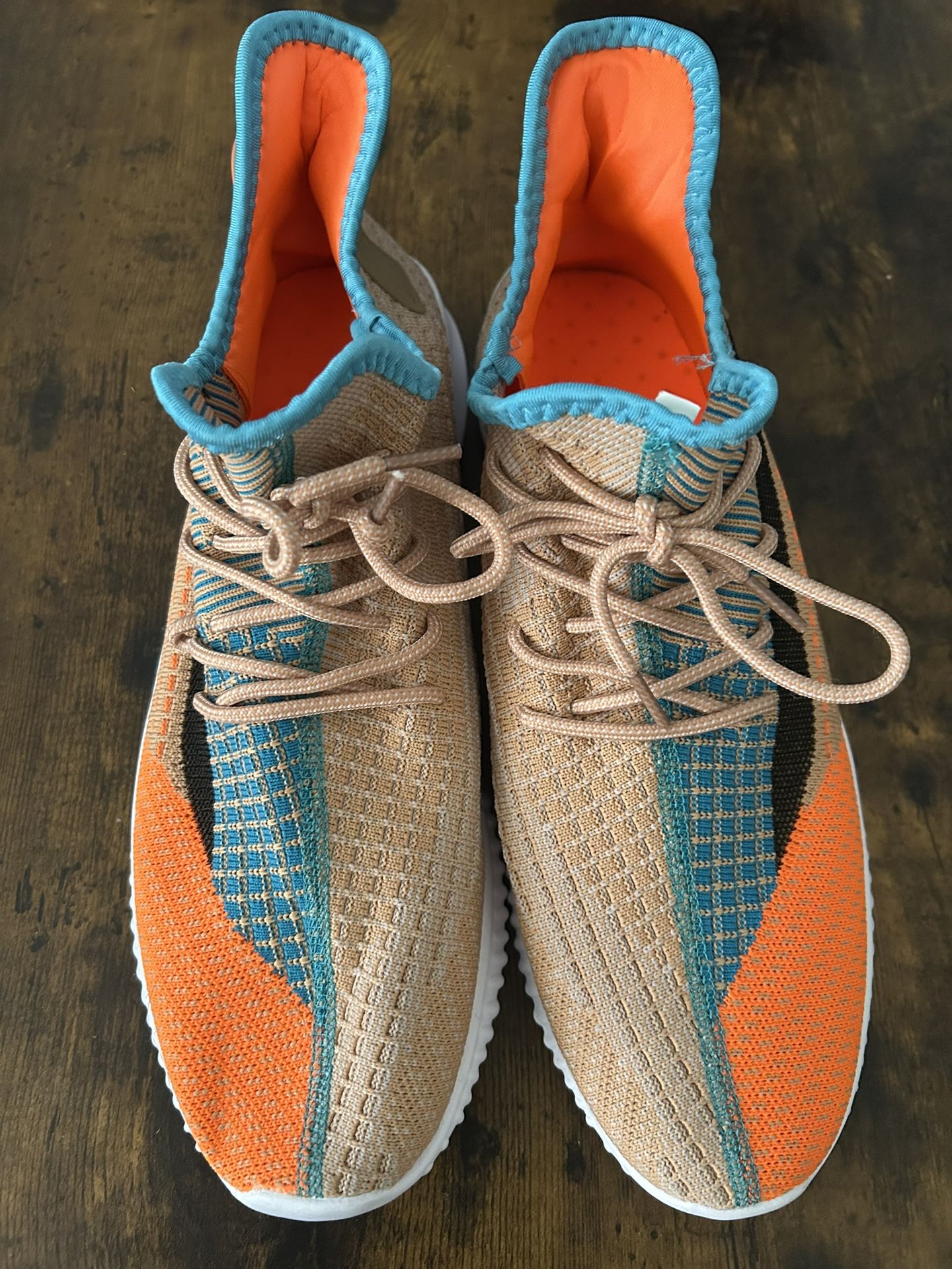 Size 11 / Supermo branded sneakers. The name "Supermo" can be seen on the heel pull tabs of the shoes in a teal/blue color.