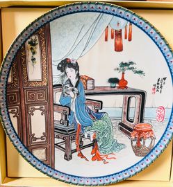 This porcelain collector plate is from the "Beauties of the Red Mansion" series produced by Imperial Jingdezhen.
