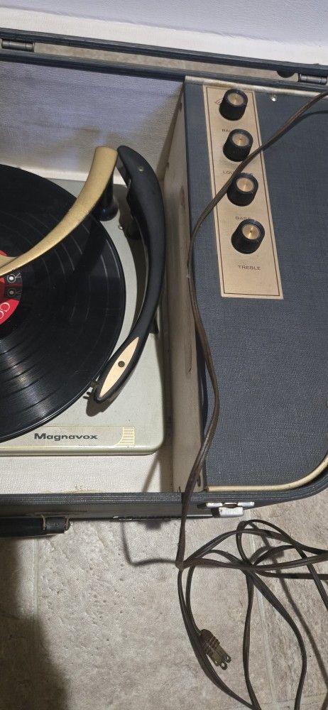 vintage Magnavox Micromatic portable record player, specifically a stereo unit often featuring fold-out speakers and a record changer capable of playi