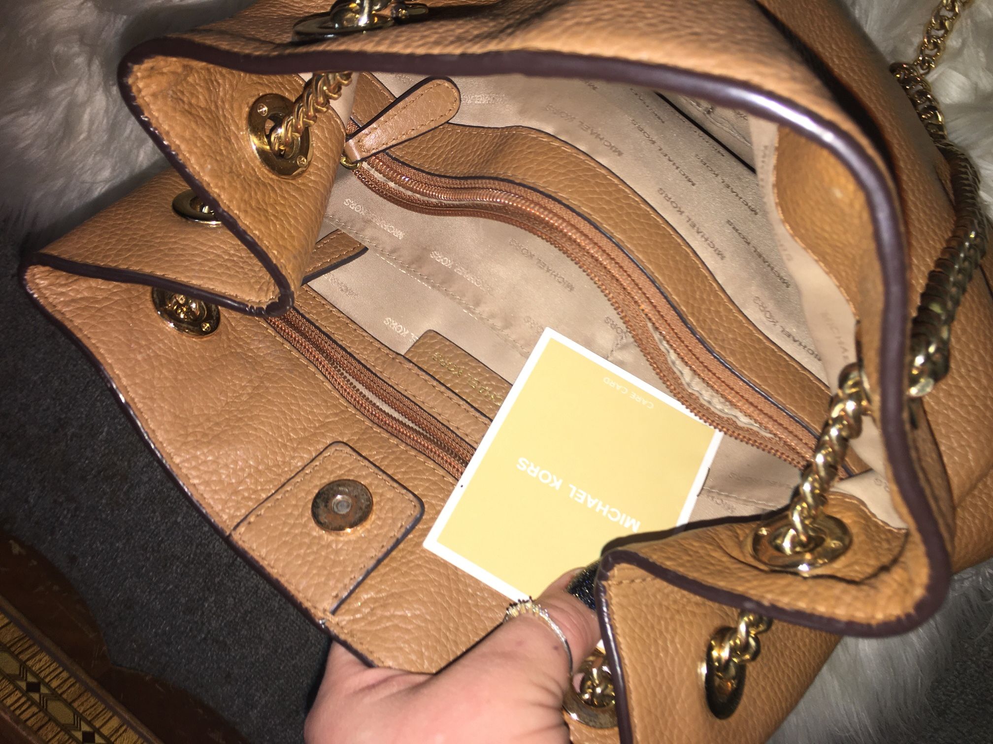 Tan leather Michael Kors purse with gold chain strap that you can use for a cross body or tote size