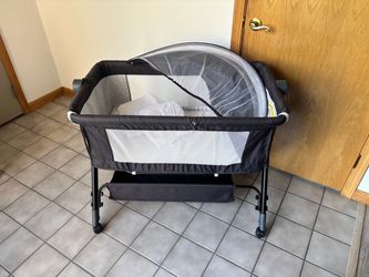 Baby Bassinet (Barely touched) w/ Storage Basket, Unzips for Bedside, Adjustable Height w/ Removable Mesh Canopy, Wheels, & 2 Waterproof Covers