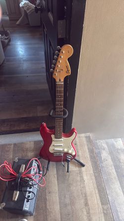 Electric guitar squire strat and plug in.