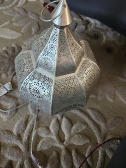 Decorative metal lantern.Middle Eastern style. The lantern features intricate, geometric perforated patterns