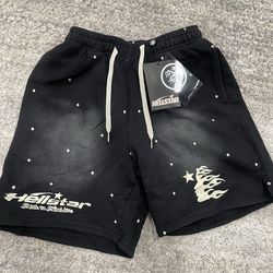Hellstar black shorts with white stars and flame design