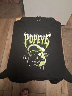 Black Pullover Hoodie features a gothic-style neon green and white "Popeye" graphic