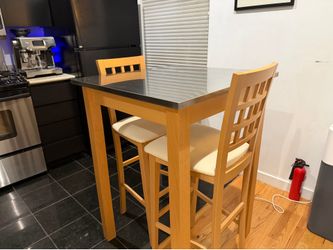Stainless steel top table and 2 matching chairs. Excellent condition!